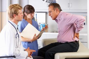 man consults with doctors